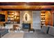 Inviting living room features a stone fireplace, built-in bookshelves and wood-paneled ceiling, creating a cozy ambiance at 1020 E 51St St, Indianapolis, IN 46205