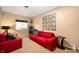 Cozy living room features vibrant red sofas and eclectic wall decor, creating a fun and inviting atmosphere at 1020 E 51St St, Indianapolis, IN 46205