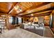 Expansive living room showcasing a stone fireplace, wood-paneled ceiling, and built-in bookshelves, perfect for relaxation at 1020 E 51St St, Indianapolis, IN 46205