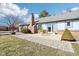 A paved walkway and backyard patio extend from the home to the outdoors, offering great outdoor living at 10709 E County Road 100 N, Indianapolis, IN 46234