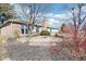 Landscaped backyard including a circular patio area and mature trees at 10709 E County Road 100 N, Indianapolis, IN 46234