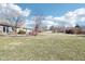 Expansive backyard with a level lawn, mature trees, and plenty of space for outdoor activities at 10709 E County Road 100 N, Indianapolis, IN 46234