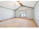 Inviting bedroom with vaulted ceilings, large window, and neutral-colored carpet at 10709 E County Road 100 N, Indianapolis, IN 46234