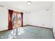 Bright bedroom featuring sliding glass door access to outdoor area at 10709 E County Road 100 N, Indianapolis, IN 46234