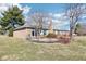 Charming brick home featuring a cozy patio, bay windows, and well-maintained landscaping at 10709 E County Road 100 N, Indianapolis, IN 46234