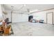 View of an empty two car garage, ready for use, featuring plenty of storage space at 10709 E County Road 100 N, Indianapolis, IN 46234