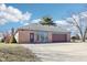 Attached garage with brown doors, brick siding, and a well-maintained driveway at 10709 E County Road 100 N, Indianapolis, IN 46234
