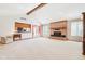Open living room with brick fireplace and neutral carpeting at 10709 E County Road 100 N, Indianapolis, IN 46234