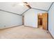 Spacious main bedroom with vaulted ceiling, ceiling fan, ensuite access and a walk-in closet at 10709 E County Road 100 N, Indianapolis, IN 46234