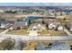An aerial view showcases a residential area with manicured lawns, tranquil ponds, and tree-lined streets, making a beautiful community at 10896 Fairwoods Dr, Fishers, IN 46037