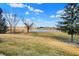 Beautiful backyard view featuring a serene pond surrounded by mature trees, creating a peaceful retreat at 10896 Fairwoods Dr, Fishers, IN 46037