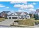Stunning home with a three-car garage, pristine landscaping, and a welcoming front yard, with great curb appeal at 10896 Fairwoods Dr, Fishers, IN 46037