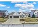 Beautiful home featuring a three-car garage, pristine landscaping, and a welcoming front yard perfect for families at 10896 Fairwoods Dr, Fishers, IN 46037