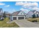 Attractive home boasts a three-car garage, manicured landscaping, and a spacious driveway, exuding curb appeal at 10896 Fairwoods Dr, Fishers, IN 46037