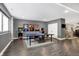 Basement game room with ping pong table, arcade games, and adjacent dining area at 10896 Fairwoods Dr, Fishers, IN 46037