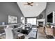 Cozy living room with high ceilings, fireplace, and natural light, perfect for relaxing and entertaining guests at 10896 Fairwoods Dr, Fishers, IN 46037