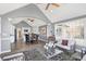 Open concept living room flows to the kitchen and features a vaulted ceiling and many windows at 10896 Fairwoods Dr, Fishers, IN 46037