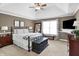 Comfortable main bedroom with a ceiling fan, neutral walls, carpeted floors, and decorative accents at 10896 Fairwoods Dr, Fishers, IN 46037