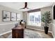 Comfortable office with modern lighting, large windows, decorative plant, and sleek wooden desk at 10896 Fairwoods Dr, Fishers, IN 46037