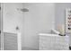 Close-up of walk-in shower featuring white tile, a shower head, and a built-in corner seat at 10896 Fairwoods Dr, Fishers, IN 46037