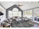 Bright sunroom with many windows, neutral furniture, light colored floors, and a ceiling fan at 10896 Fairwoods Dr, Fishers, IN 46037