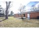 Brick house exterior featuring a back patio and a spacious green yard with mature trees at 118 Beechwood Dr, Westfield, IN 46074
