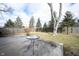 Concrete patio with outdoor table, mature trees, and a fenced perimeter at 118 Beechwood Dr, Westfield, IN 46074