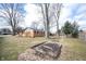 Spacious backyard showing grass, trees, a bare patch, and an external view of the house at 118 Beechwood Dr, Westfield, IN 46074