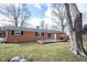 Brick house with a backyard featuring a patio and a spacious green yard with mature trees at 118 Beechwood Dr, Westfield, IN 46074