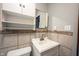 Bathroom features vanity, sink, mirror, and toilet with decorative backsplash at 118 Beechwood Dr, Westfield, IN 46074
