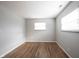 Empty bedroom with wood floors, two windows, and neutral wall color at 118 Beechwood Dr, Westfield, IN 46074