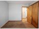 Empty bedroom features hardwood floors, closet with paneled wood door, and walk-through to the bathroom at 118 Beechwood Dr, Westfield, IN 46074