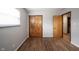 Bedroom with hardwood floors features closet with paneled wood door at 118 Beechwood Dr, Westfield, IN 46074