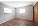 Bright bedroom features gleaming hardwood floors and abundant natural light from two windows at 118 Beechwood Dr, Westfield, IN 46074