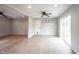 Bright living area with tile flooring, a ceiling fan, and a sliding glass door leading to the backyard at 118 Beechwood Dr, Westfield, IN 46074