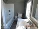 Functional bathroom showcasing a tub, toilet, and well-lit sink area at 1311 E Hines St, Muncie, IN 47303