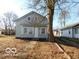 Charming home featuring a front yard with a large tree providing shade at 1311 E Hines St, Muncie, IN 47303