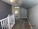 Upstairs hallway showcasing a white railing and doorway to a bathroom at 1311 E Hines St, Muncie, IN 47303