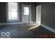 Bright living room featuring two windows and a doorway, with carpeting, ready for your personal touch at 1311 E Hines St, Muncie, IN 47303