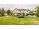 Backyard featuring a trampoline, patio furniture, and lush landscaping at 14297 Matt St, Carmel, IN 46033