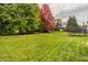 A stunning backyard with mature trees, including one with vibrant red leaves at 14297 Matt St, Carmel, IN 46033