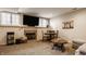 Cozy basement with a fireplace, entertainment center, game table, and comfortable seating for relaxation at 14297 Matt St, Carmel, IN 46033
