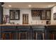Close-up of the finished basement bar, showcasing custom cabinetry, a wine rack, and stylish lighting at 14297 Matt St, Carmel, IN 46033