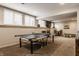 Finished basement with ping pong table, large windows providing natural light, and versatile space for various activities at 14297 Matt St, Carmel, IN 46033
