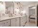 This bathroom features a floral accent wall and double vanity sinks with gold hardware and fixtures at 14297 Matt St, Carmel, IN 46033