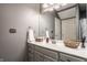 Bathroom with gray vanity, white countertop, decorative baskets, and a large mirror at 14297 Matt St, Carmel, IN 46033