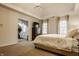 Spacious bedroom with tray ceiling, walk-in closet, and adjacent exercise room at 14297 Matt St, Carmel, IN 46033