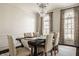 Well-lit dining room features a large table, stylish curtains, and arched windows, creating an inviting atmosphere at 14297 Matt St, Carmel, IN 46033