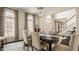 Bright dining room with arched windows, open to the foyer, blending natural light and elegant design at 14297 Matt St, Carmel, IN 46033