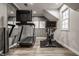 Home gym with modern exercise equipment, stylish wallpaper, and ample lighting for effective workouts at 14297 Matt St, Carmel, IN 46033